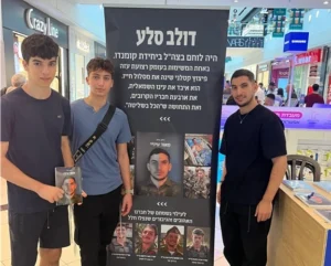 תלמידי ישיבת אמית כפר גנים מפתח תקווה עם גיבור ישראל דולב סלע (מימין) בדוכן ספרו "מאור עיניי".